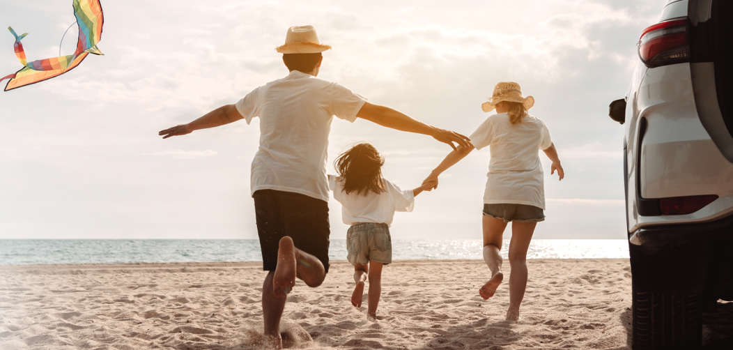 Family enjoying vacation with a car in a beach